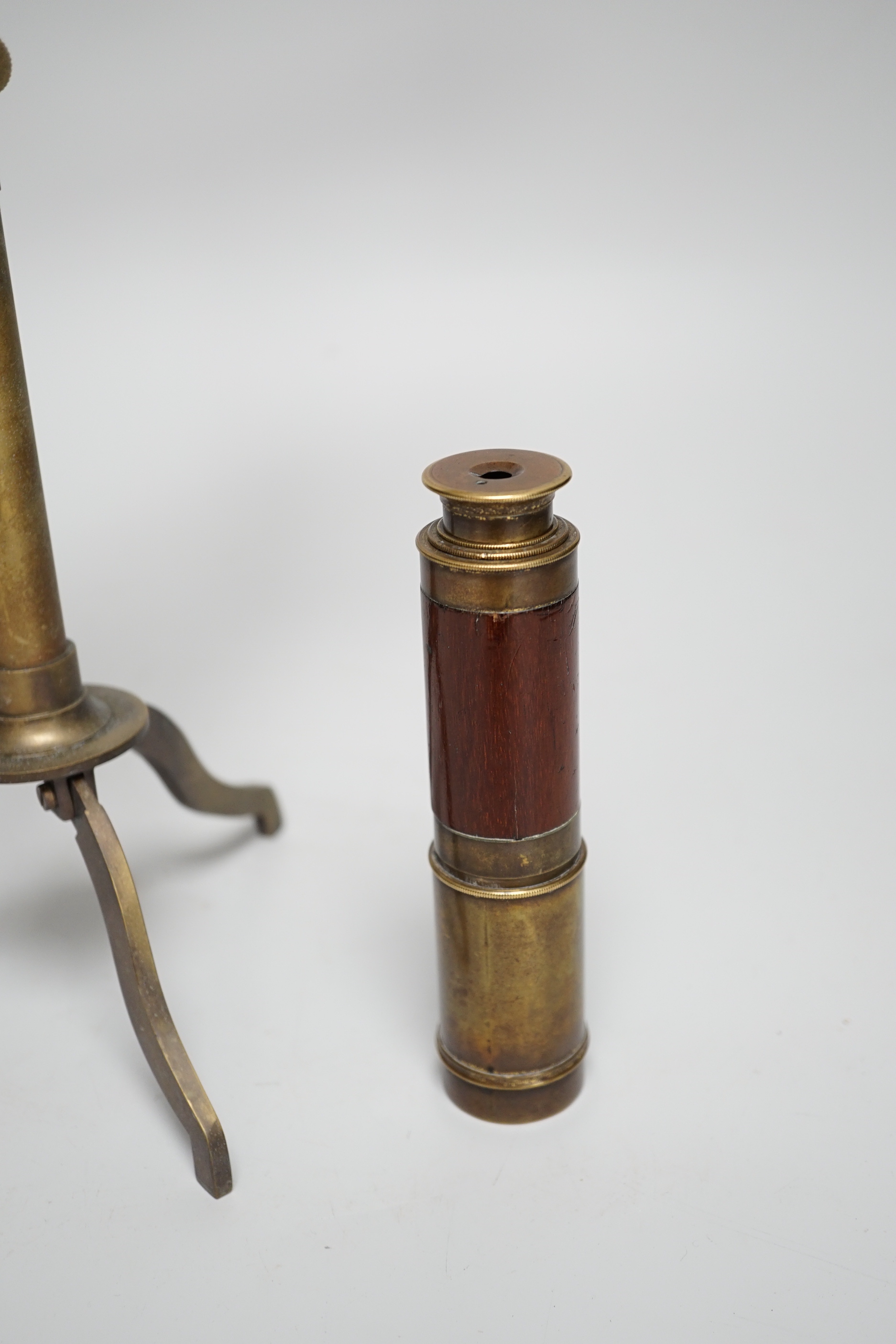 A brass telescope on tripod stand, signed Ottway, Ealing, 28cm high, together with a three-draw telescope